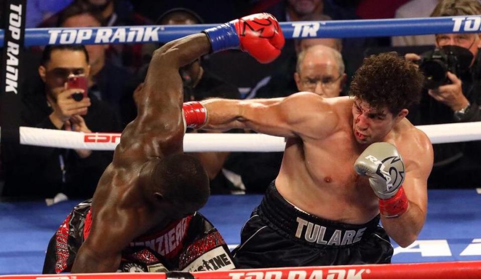 Tulare heavyweight Richard Torrez Jr. lands a right punch on Allen Melson of Alabama during the second round at the Save Mart Center on March 4, 2022.