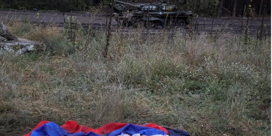The Russian tricolor near a destroyed enemy tank in Izyum, Kharkiv Oblast, liberated from the invaders
