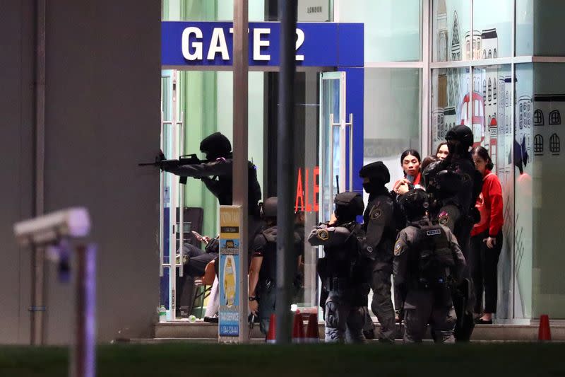 Thailand security forces enter in a shopping mall as they chase a shooter hidden in after a mass shooting in front of the Terminal 21, in Nakhon Ratchasima, Thailand