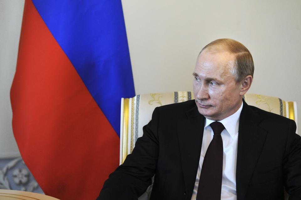 Russian President Vladimir Putin listens to his Kyrgyz counterpart Almazbek Atambayev (not pictured) during their meeting at the Constantine (Konstantinovsky) Palace in St. Petersburg March 16, 2015. Putin laughed off suggestions he had been forced to lie low because of poor health, saying on Monday that life would be "boring without gossip". REUTERS/Mikhail Klimentyev/RIA Novosti/Kremlin (RUSSIA - Tags: POLITICS) ATTENTION EDITORS - THIS IMAGE HAS BEEN SUPPLIED BY A THIRD PARTY. IT IS DISTRIBUTED, EXACTLY AS RECEIVED BY REUTERS, AS A SERVICE TO CLIENTS