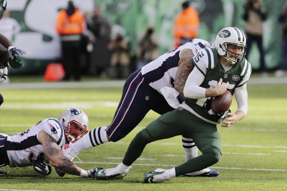 New England Patriots' Lawrence Guy, center, tackles New York Jets quarterback Josh McCown, right, during the first half of an NFL football game Sunday, Nov. 25, 2018, in East Rutherford, N.J. (AP Photo/Seth Wenig)