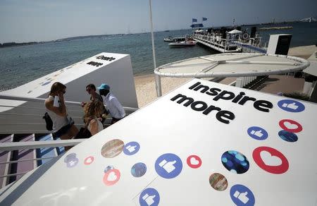 Logos of the social network Facebook are seen on a beach during the Cannes Lions in Cannes, France, June 21, 2017. REUTERS/Eric Gaillard/Files