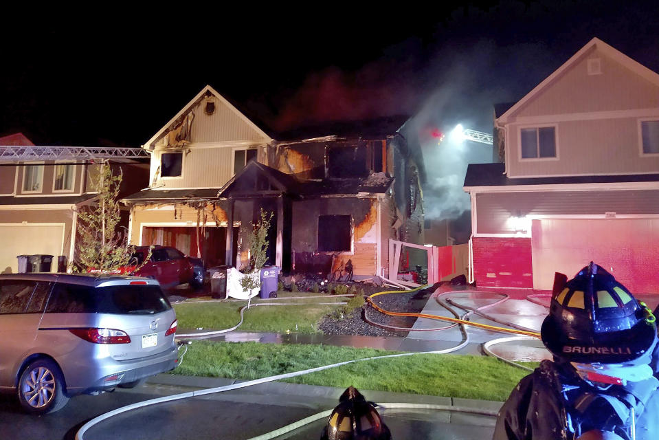 This photo from the Denver Fire Department shows the house where multiple people were found dead in fire that authorities suspect was intentionally set, early Wednesday, Aug. 5, 2020. A Denver Fire Department spokesman says three people who were on the the upper story of the house managed to escape but the fire's heat pushed back a police officer trying to rescue those on the first floor. (Denver Fire Department via AP)