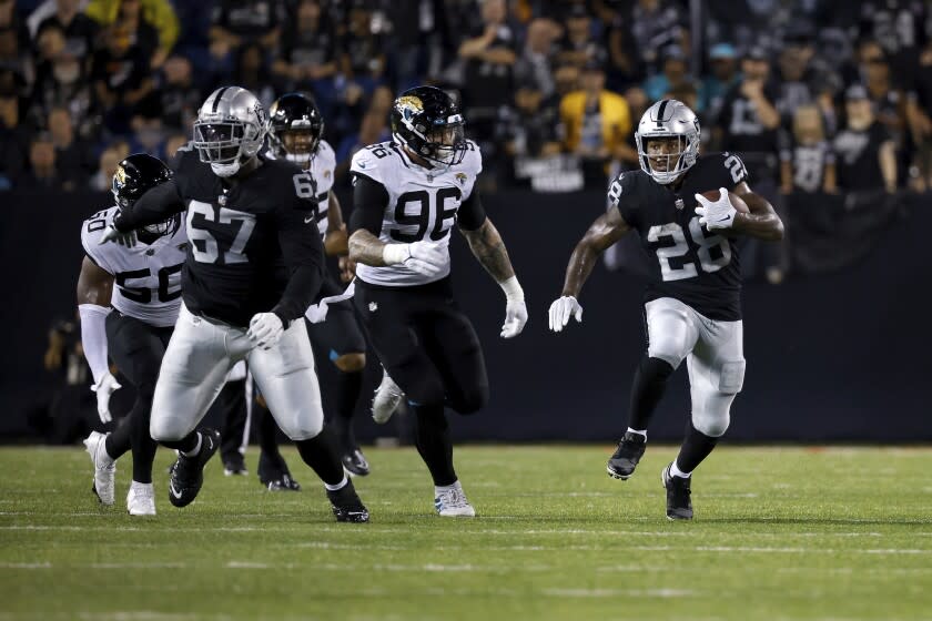 Las Vegas Raiders running back Josh Jacobs (28) runs the ball up the field during an NFL preseason football game against the Jacksonville Jaguars, Thursday, Aug. 4, 2022, in Canton, Ohio. (AP Photo/Kirk Irwin)