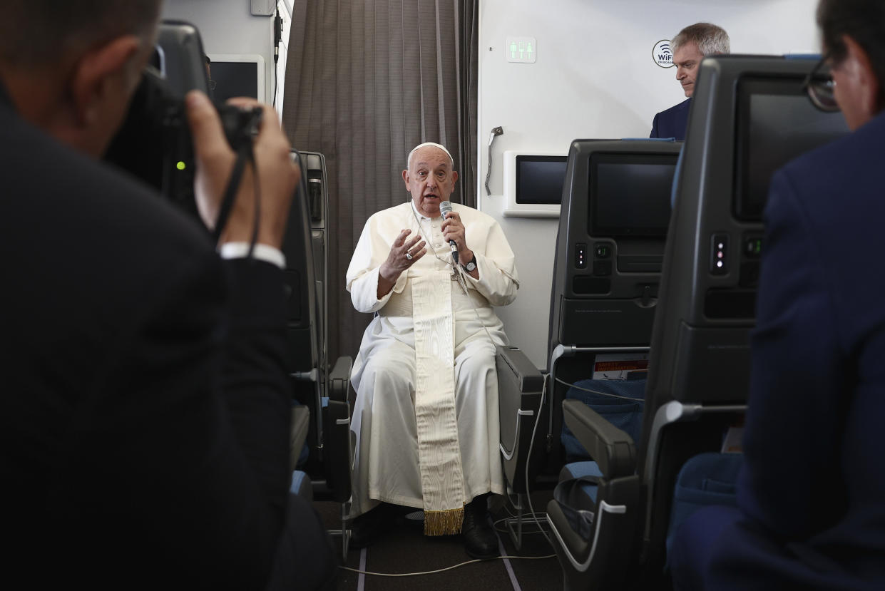 Pope Francis holds a news conference aboard the papal plane on his flight back after his 12-day journey across Southeast Asia and Oceania, Friday, Sept. 13, 2024. (Guglielmo Mangiapane/Pool Photo via AP)