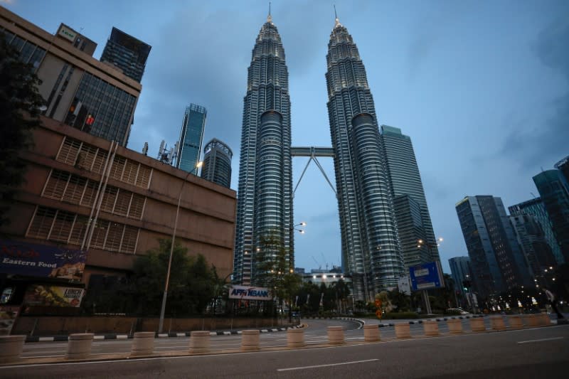 An empty street is seen in front of Petronas Twin Towers after Malaysia's government announced the movement control order due to the spread of the coronavirus disease (COVID-19), in Kuala Lumpur