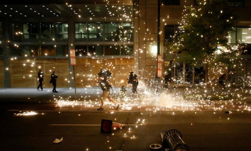 People run as police disperse protesters in Washington DC.