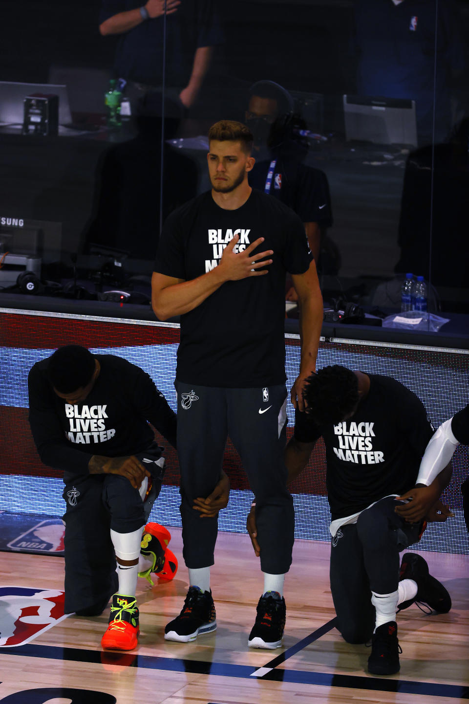 Miami Heat's Meyers Leonard stands during the national anthem before an NBA basketball game against the Denver Nuggets, Saturday, Aug. 1, 2020, in Lake Buena Vista, Fla. (Kevin C. Cox/Pool Photo via AP)