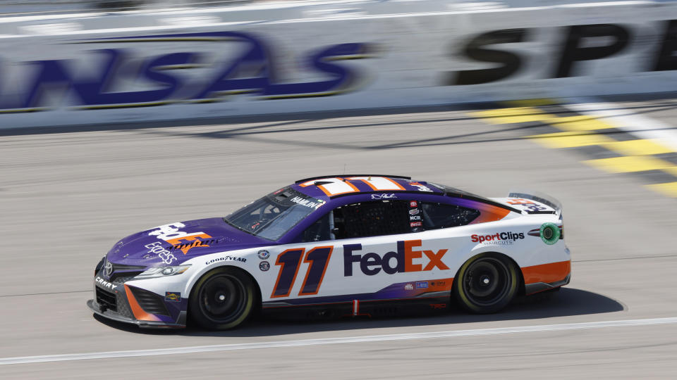 Denny Hamlin heads toward Turn 1 during a NASCAR Cup Series auto race at Kansas Speedway in Kansas City, Kan., Sunday, May 7, 2023. (AP Photo/Colin E. Braley)