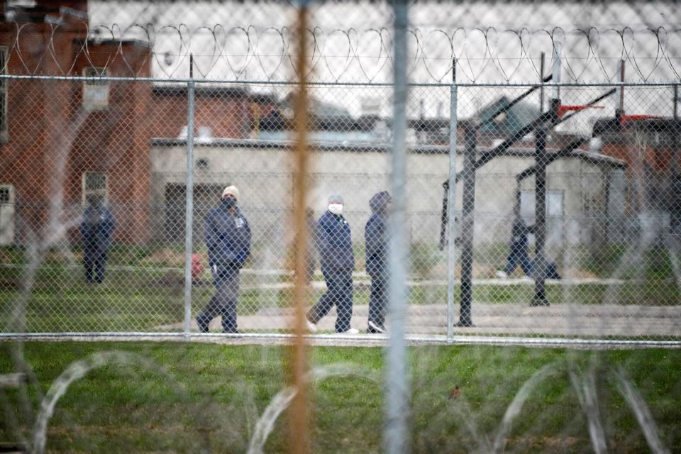 People walk in the yard at Marion Correctional Institution on April 22, just after the prison completed mass testing for the coronavirus. (Photo: Dane Rhys/Reuters)