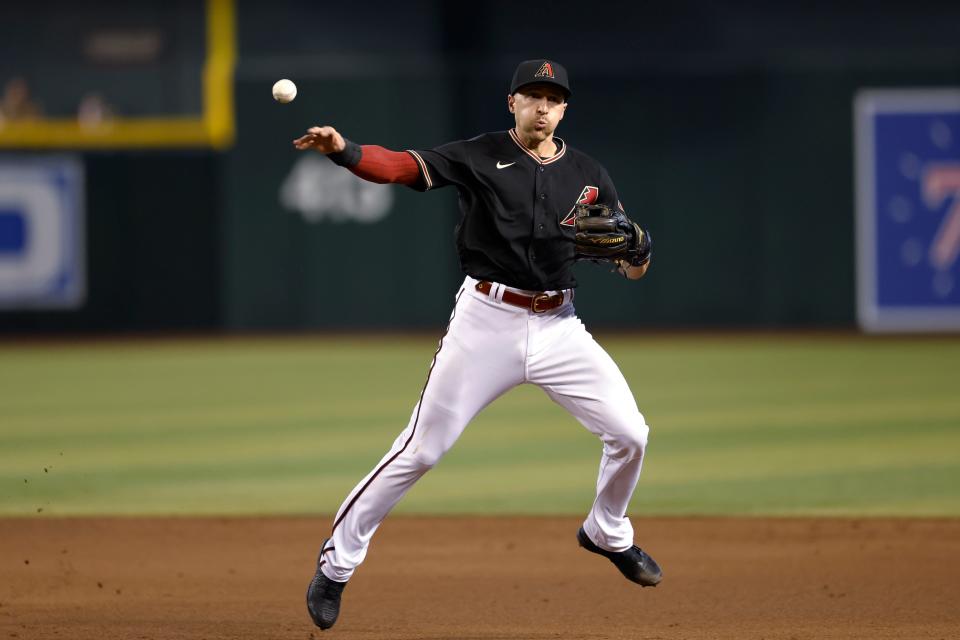 Arizona Diamondbacks shortstop Nick Ahmed throws to first for the out on Chicago Cubs' Ian Happ during the sixth inning of a baseball game Saturday, May 14, 2022, in Phoenix. (AP Photo/Chris Coduto)