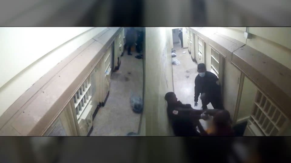 In this video still, a group of guards attempts to subdue Gershun Freeman outside his cell. - Shelby County Sheriff's Office
