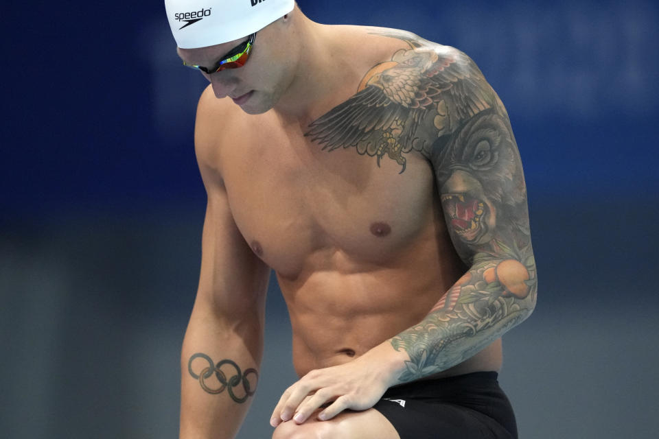 Caeleb Dressel of the United States stands on the start blocks for his heat of the men's 100-meter freestyle at the 2020 Summer Olympics, Tuesday, July 27, 2021, in Tokyo, Japan. (AP Photo/Matthias Schrader)