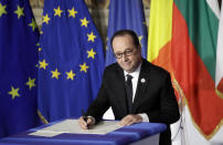 French President Francois Hollande signs a declaration during an EU summit meeting at the Orazi and Curiazi Hall in the Palazzo dei Conservatori in Rome on Saturday, March 25, 2017. European Union leaders were gathering in Rome to mark the 60th anniversary of their founding treaty and chart a way ahead following the decision of Britain to leave the 28-nation bloc. (AP Photo/Alessandra Tarantino)