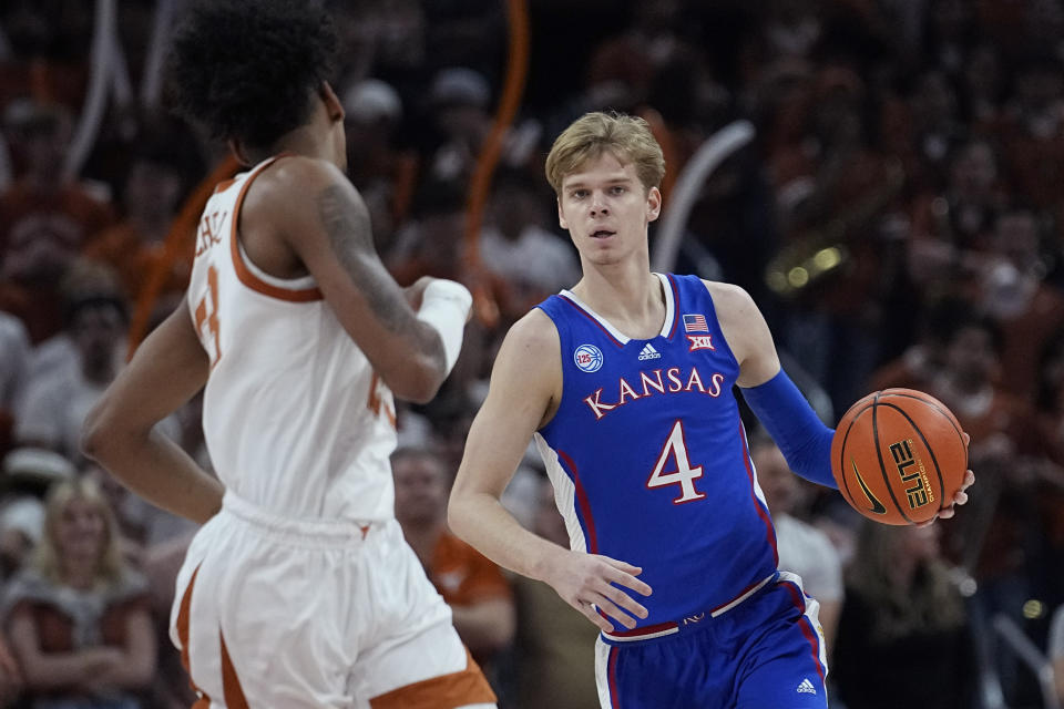 Kansas guard Gradey Dick (4) brings the ball up court against Texas forward Dillon Mitchell (23) during the first half of an NCAA college basketball game in Austin, Texas, Saturday, March 4, 2023. (AP Photo/Eric Gay)