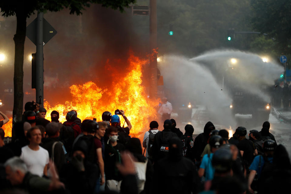 <p>Riot police use water cannon against protesters who have set barricades alight on July 7, 2017 in Hamburg, northern Germany, where leaders of the world’s top economies gather for a G20 summit. (Photo: Odd Andersen/AFP/Getty Images) </p>