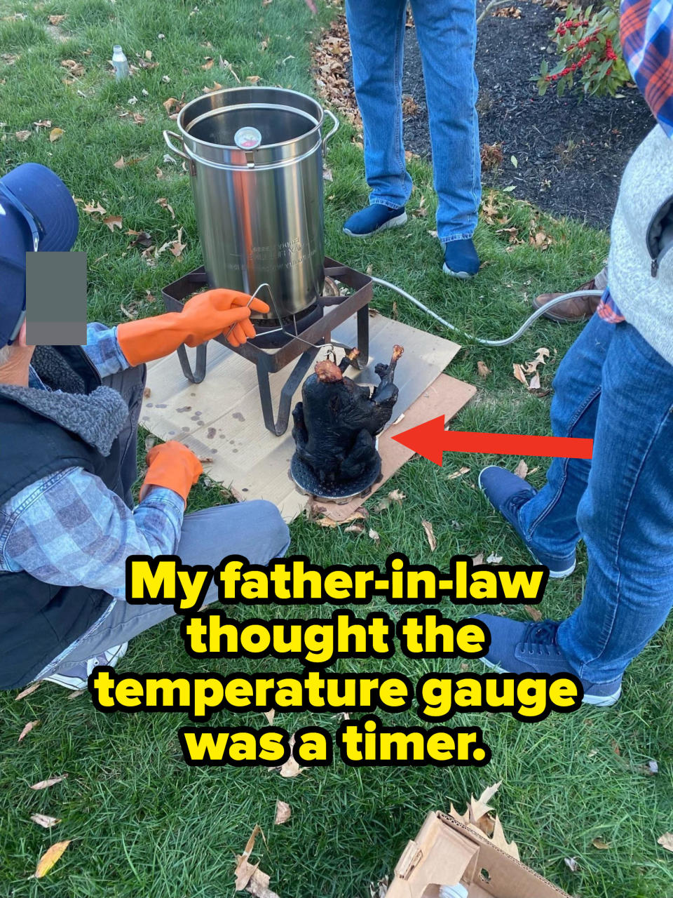 Blackened turkey on the grass with caption: My father in law thought the temperature gauge was a timer