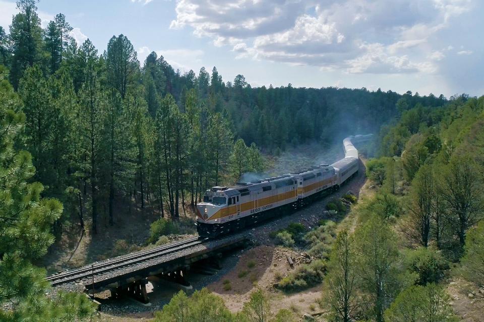 The train going through mountains by The Grand Canyon Railway &amp; Hotel