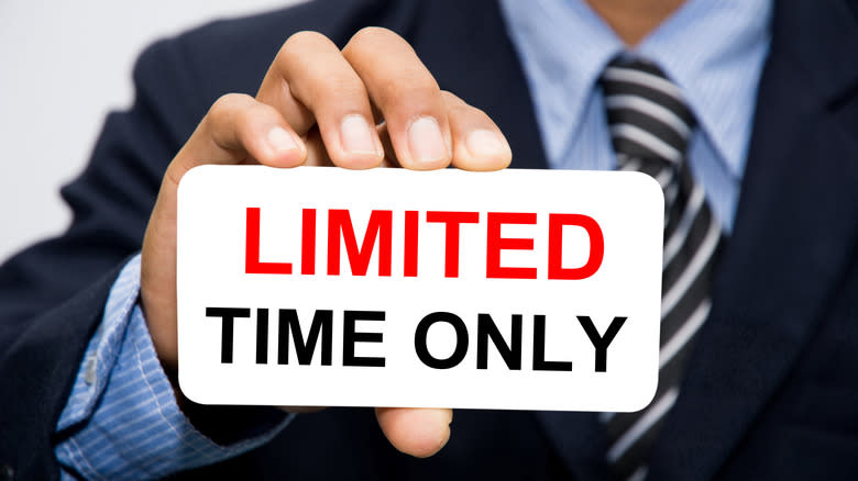 Man holding sign that says Limited Time Only