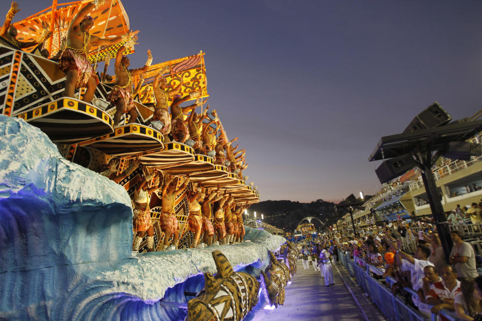 Performers from the Unidos da Vila Isabel samba school parade during carnival celebrations at the Sambadrome in Rio de Janeiro, Brazil, Monday, Feb.20, 2012.    Millions watched the sequin-clad samba dancers at Rio de Janeiro's iconic Carnival parade.  (AP Photo/Victor R. Caivano)