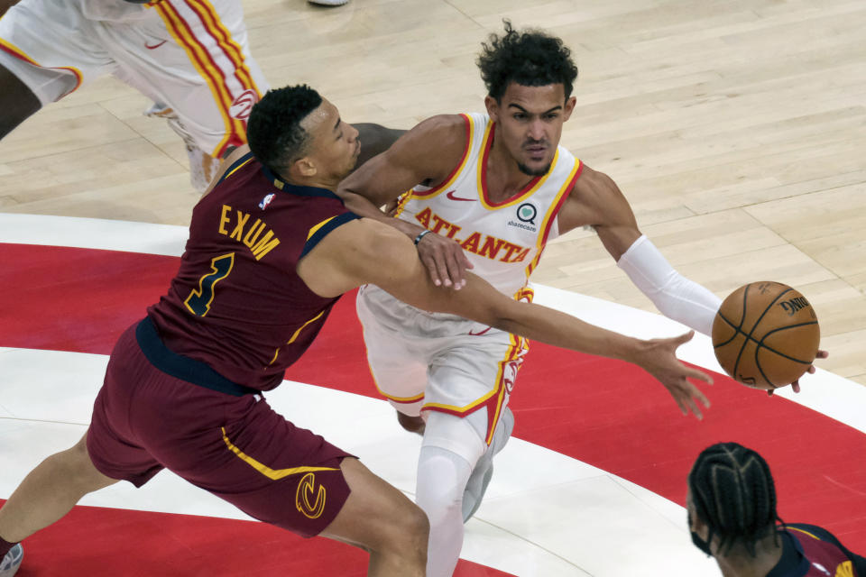 Atlanta Hawks guard Trae Young (11) is fouled by Cleveland Cavaliers guard Dante Exum (1) during the first half of an NBA basketball game on Saturday, Jan. 2, 2021 in Atlanta. (AP Photo/Ben Gray)