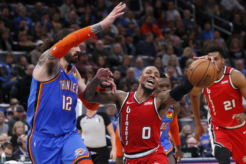 Portland Trail Blazers guard Damian Lillard (0) drives around Oklahoma City Thunder center Steven Adams (12) in the first half of an NBA basketball game Saturday, Jan. 18, 2020, in Oklahoma City. (AP Photo/Sue Ogrocki)