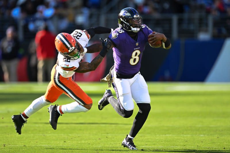 Baltimore Ravens quarterback Lamar Jackson (R) pushes Cleveland Browns safety Grant Delpit on Sunday at M&T Bank Stadium in Baltimore. Photo by David Tulis/UPI