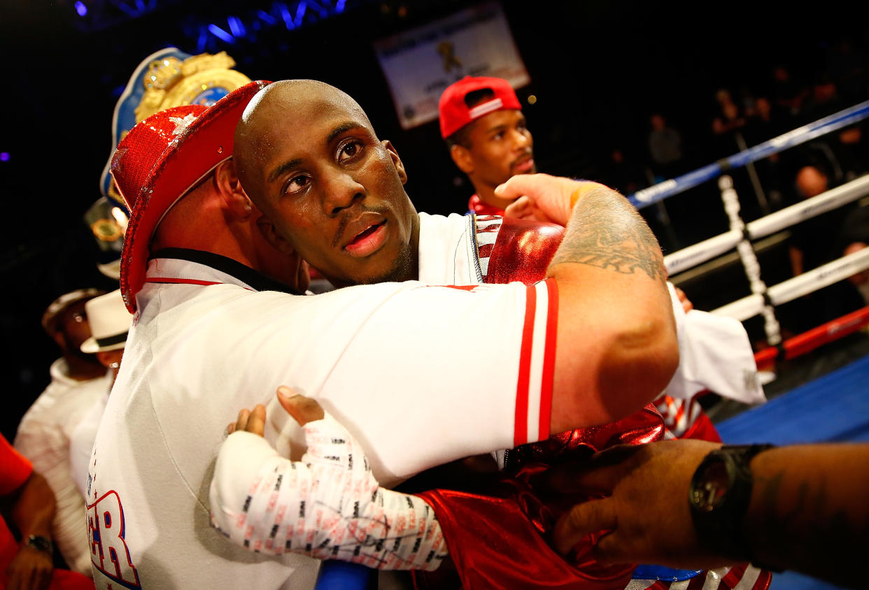 Tevin Farmer celebrates with his team following the junior lightweight win against Emmanuel Gonzalez. (Getty)