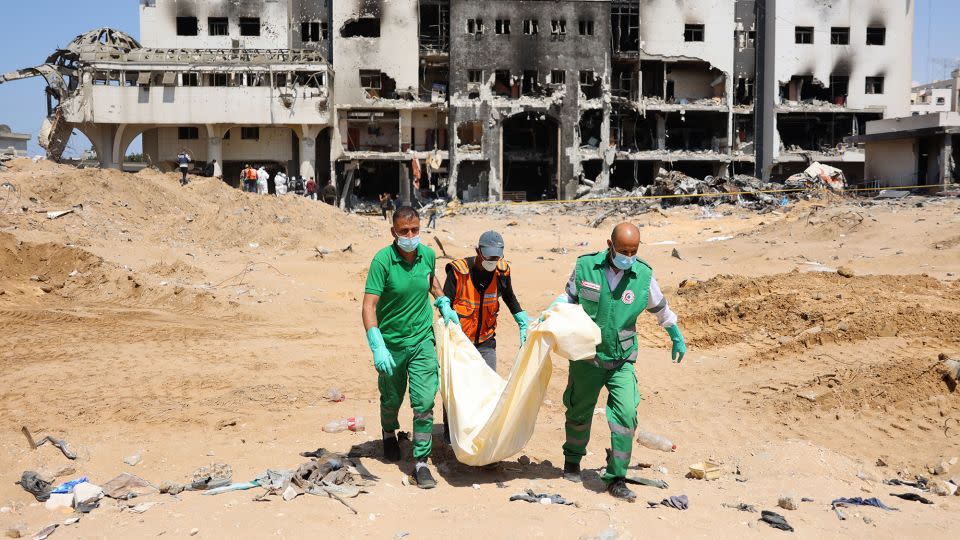 Palestinian forensic and civil defense workers recover human remains at the grounds of Al-Shifa, Gaza's largest hospital, which was reduced to rubble by a two-week Israeli raid, on April 8, 2024. - AFP/Getty Images