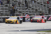 Clint Bowyer (14) and Martin Truex Jr. (19) make their way down the front stretch during the NASCAR Cup Series auto race at Texas Motor Speedway in Fort Worth, Texas, Wednesday, Oct. 28, 2020. (AP Photo/Richard W. Rodriguez)