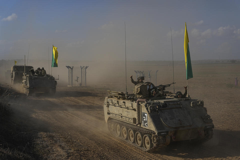 Israeli armored personnel carriers head toward the border with the Gaza Strip in southern Israel, Sunday, Oct. 15, 2023. (AP Photo/Ohad Zwigenberg)