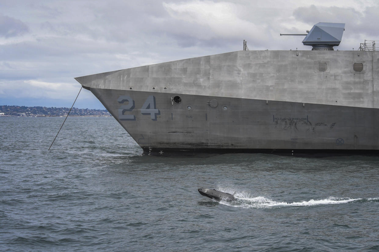 In this handout image from the U.S. Navy, an ADARO unmanned drone passes by the USS Oakland during a drill April 22, 2021, off Coronado, California. The U.S. Navy's Mideast-based 5th Fleet said Wednesday, Sept. 8, 2021, it will launch a new task force that incorporates airborne, sailing and underwater drones after years of maritime attacks linked to ongoing tensions with Iran. (U.S. Navy/Mass Communication Specialist 2nd Class Alex Perlman, via AP)