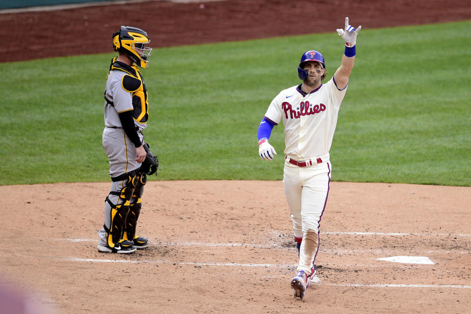 Philadelphia Phillies' Bryce Harper, right, reacts after hitting solo home run off Pittsburgh Pirates starting pitcher Wil Crowe (not shown) during the third inning of a baseball game, Saturday, Sept. 25, 2021, in Philadelphia. (AP Photo/Derik Hamilton)