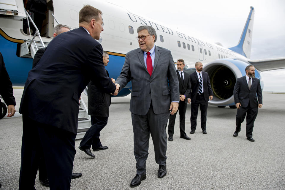 Attorney General William Barr greets members of the Cleveland FBI field office's SWAT team before boarding an aircraft at Burke Lakefront Airport, Thursday, Nov. 21, 2019, in Cleveland. Barr participated in a roundtable discussion with members of local, state and federal law enforcement, and is en route to Montana, where he is scheduled Friday to address missing and murdered indigenous persons. (AP Photo/Patrick Semansky)