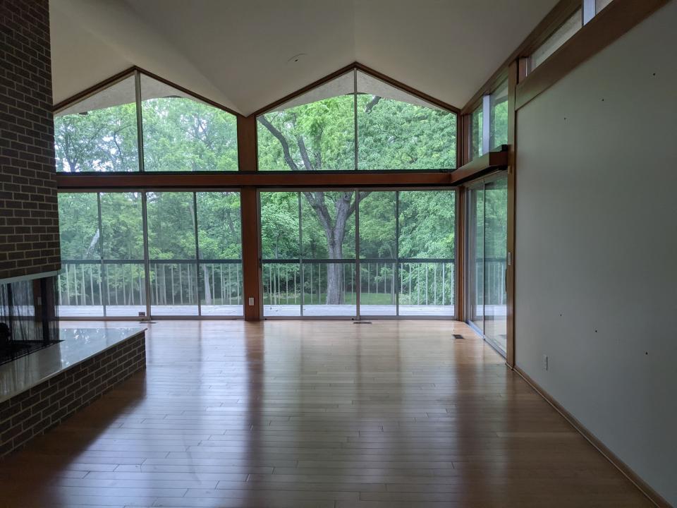 View from inside the future Montessori EARTH high school, looking out to the back of the building and mature trees on the property.