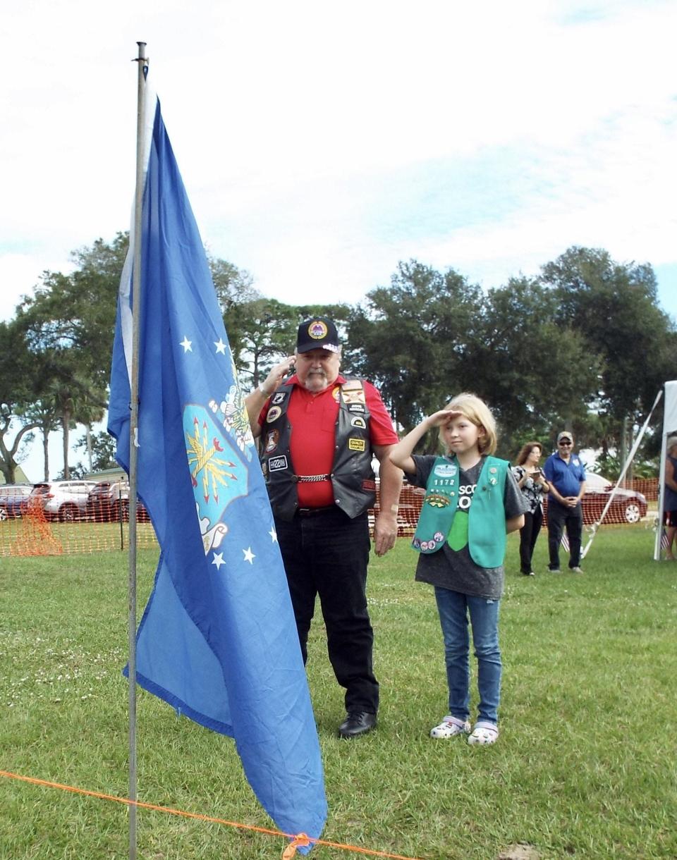 Anna Howard, a Junior Girl Scout escorted a veteran who presented the United States Marine Corps flag at a Pearl Harbor Remembrance Day ceremony in Edgewater on Sunday.