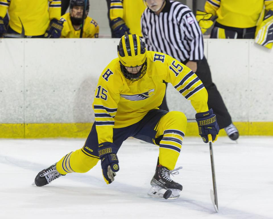 Hartland defenseman Peter Halonen attempts to keep the puck in the zone during a 5-2 victory over Birmingham Brother Rice Saturday, Dec. 10, 2022 at Eddie Edgar Ice Arena.