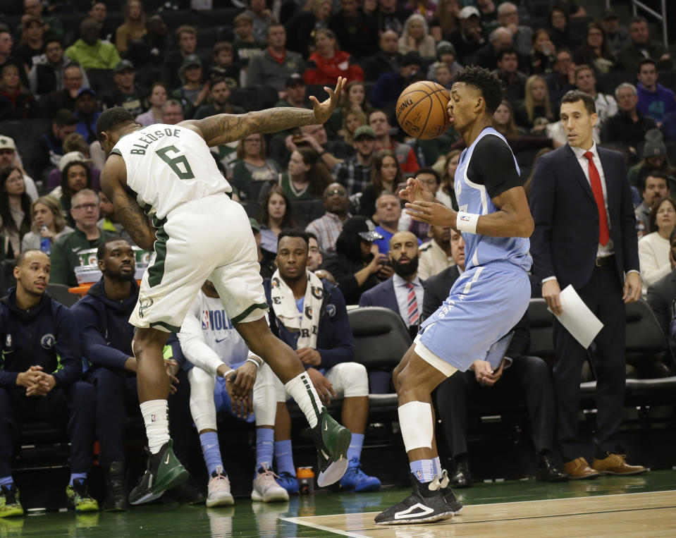 Milwaukee Bucks' Eric Bledsoe (6) throws the ball off the face of Minnesota Timberwolves' Jarrett Culver and the ball goes out of bounds awarded to Milwaukee during the first half of an NBA basketball game Wednesday, Jan. 1, 2020, in Milwaukee. (AP Photo/Jeffrey Phelps)