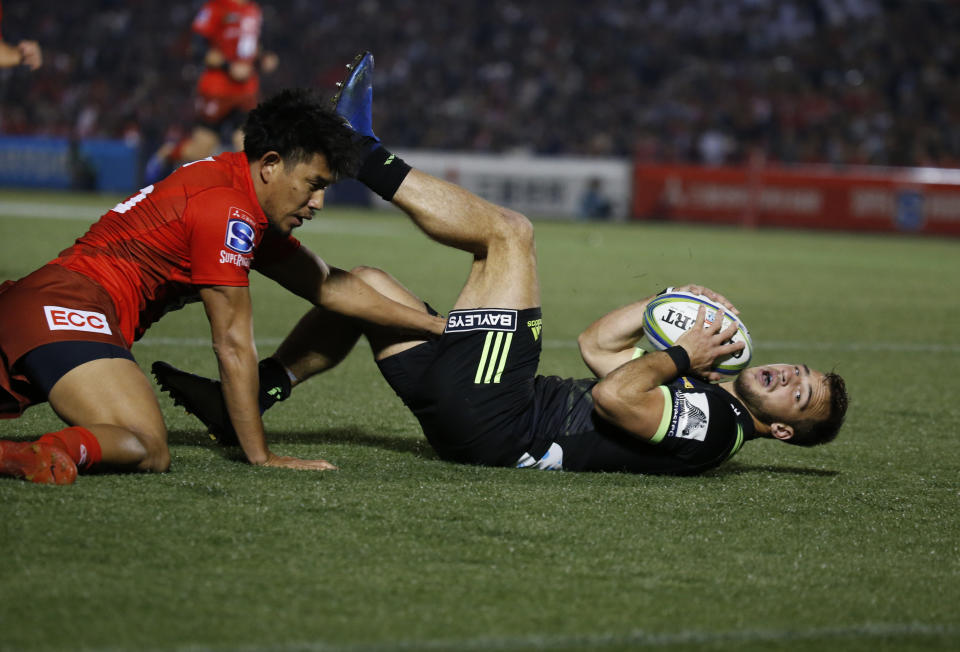 Hurricane's Wes Goosen, right, scores a goal during the Super Rugby game between the Hurricanes and Sunwolves in Tokyo, Friday, April 19, 2019. (AP Photo/Shuji Kajiyama)