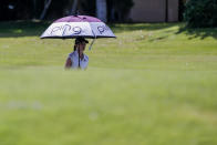 Emilia Carolina Migliaccio walks with an umbrella on the 12th hole during the first round of the ANA Inspiration golf tournament at Mission Hills Country Club in Rancho Mirage, Calif. Thursday, Sept. 10, 2020. (AP Photo/Ringo H.W. Chiu)