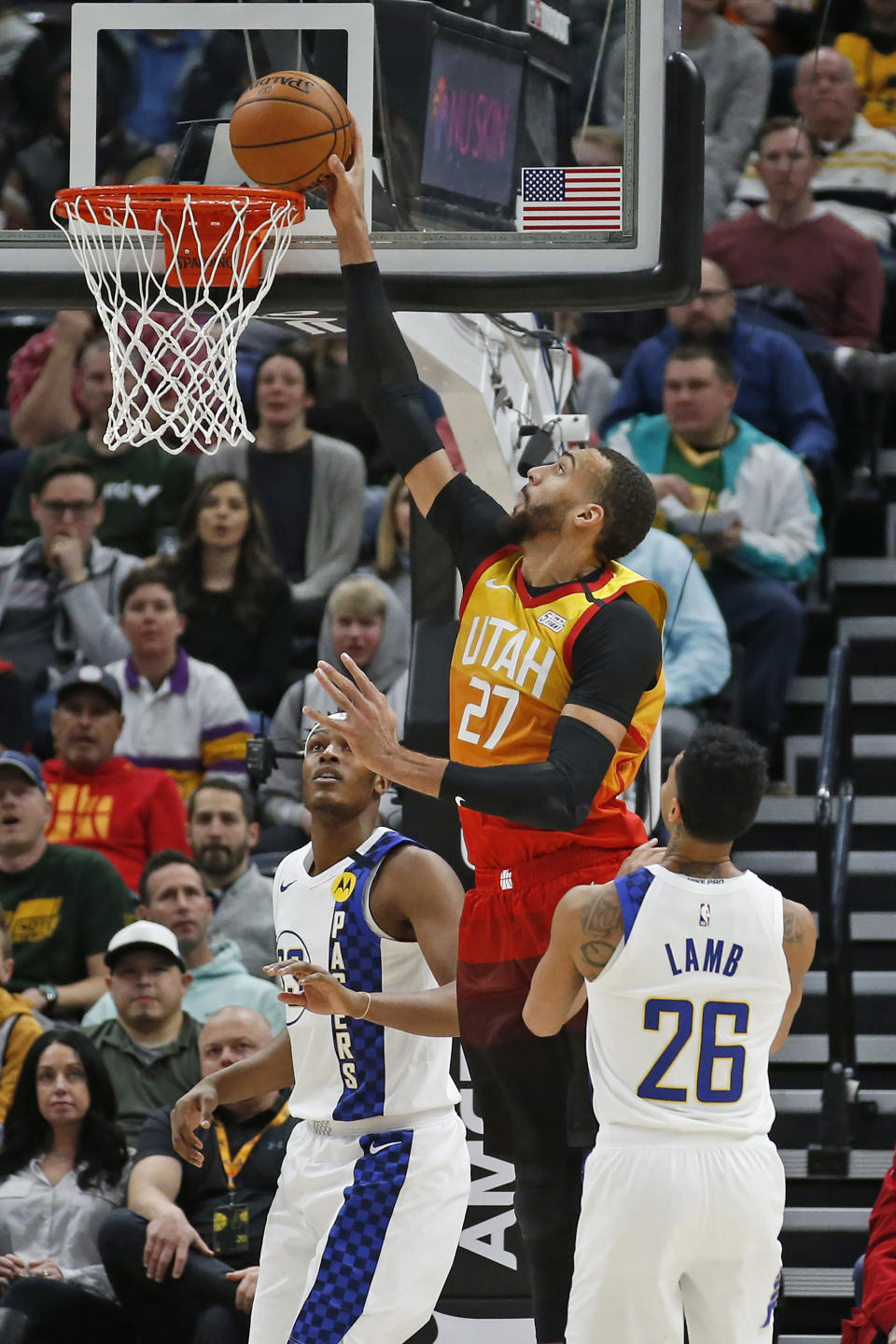 Utah Jazz center Rudy Gobert (27) dunks the ball as Indiana Pacers' Myles Turner, rear, and Jeremy Lamb (26) look on in the first half of an NBA basketball game Monday, Jan. 20, 2020, in Salt Lake City. (AP Photo/Rick Bowmer)