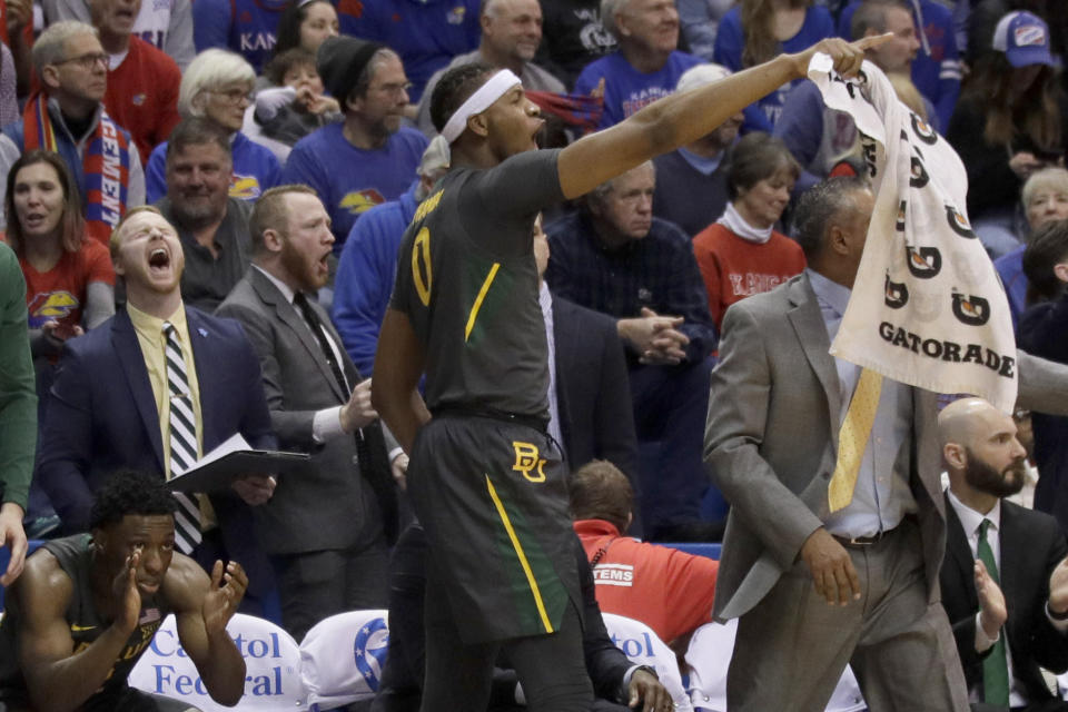 Baylor forward Flo Thamba (0) celebrates a basket from the bench during the second half of an NCAA college basketball game against Kansas in Lawrence, Kan., Saturday, Jan. 11, 2020. Baylor defeated Kansas 55-67. (AP Photo/Orlin Wagner)