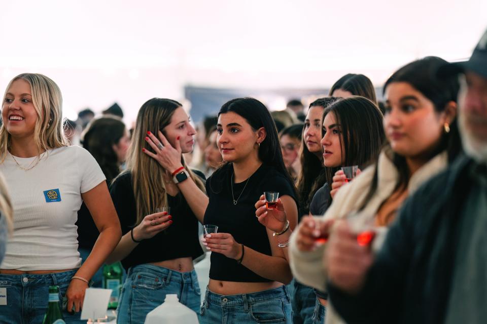 Attendees hold a small glass of wine to celebrate Shabbat at Mega Shabbat hosted by Chabad IU on March 29, 2024.