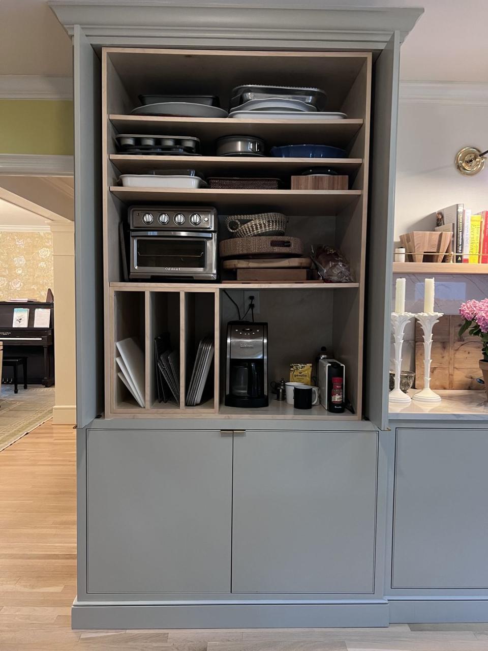 a kitchen with a shelf full of dishes and a coffee maker