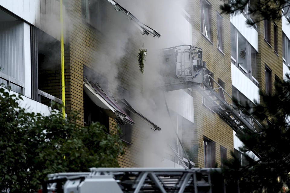 Smoke billows from an apartment building after an explosion in Annedal, central Gothenburg, Sweden, Tuesday Sept. 28, 2021. The explosion took place in the early hours of the morning, and rescue services are still working to extinguish fires that spread to several apartments. (Bjorn Larsson Rosvall/TT via AP)