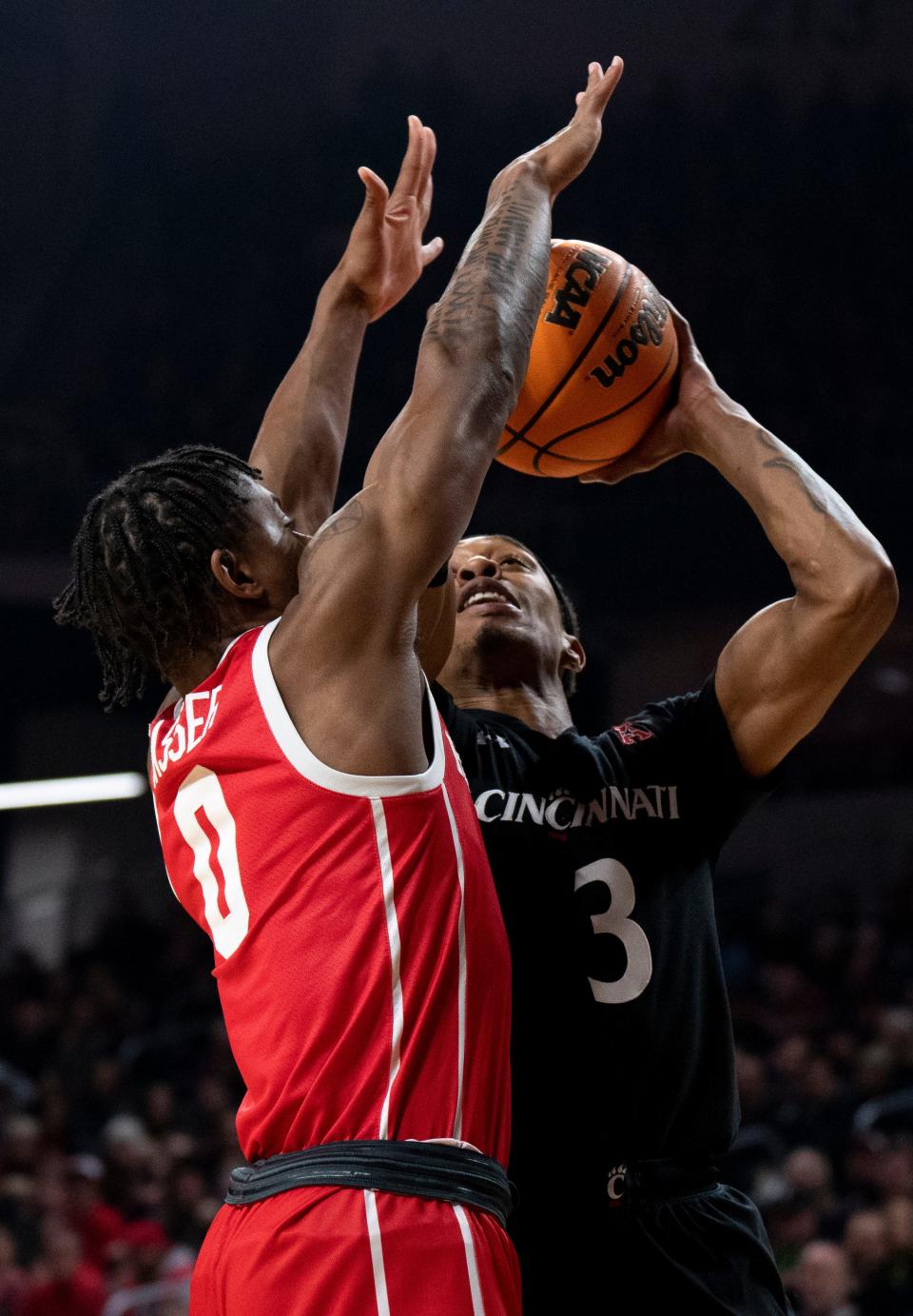 Cincinnati Bearcats guard Mika Adams-Woods (3) shoots as Houston Cougars guard Marcus Sasser (0) defends on Jan. 8. Adams-Woods led UC with 19 points and his shooting will be needed again Saturday in Houston.