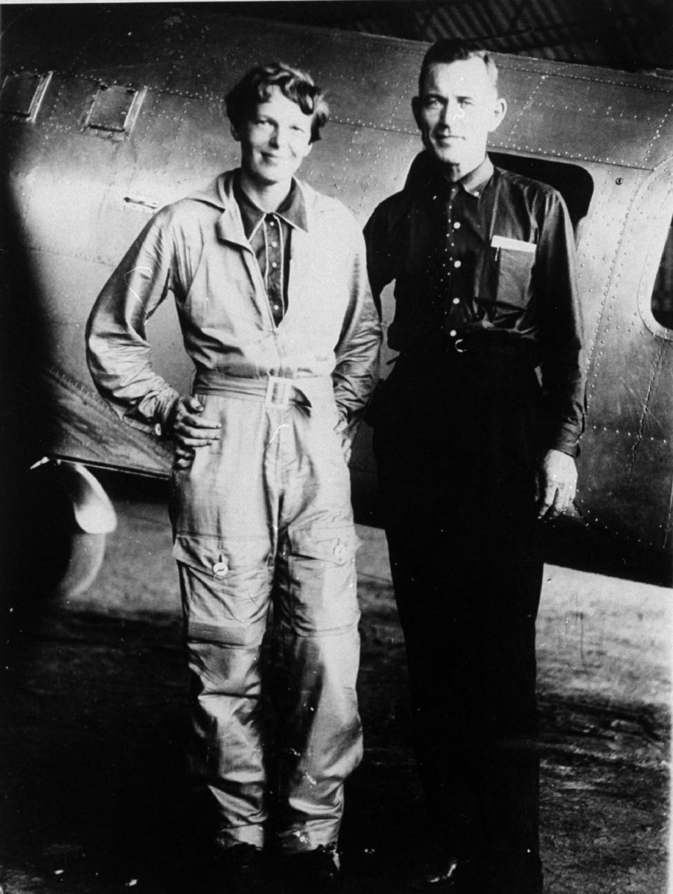 FILE - In this May 1937 file photo, American aviaor Amelia Earhart and her navigator, Fred Noonan, pose in front of their twin-engine Lockheed Electra in Los Angeles prior to their flight around the world. Earhart’s disappearance in 1937 is among aviation’s most enduring mysteries. Earhart, the first female pilot to cross the Atlantic Ocean, vanished over the Pacific with Noonan during an attempt to circumnavigate the globe. Seven decades later, people are still transfixed with the mystery. Theories range from her simply running out of fuel and crashing to her staging her own disappearance and secretly returning to the U.S. to live under another identity. (AP Photo/File)