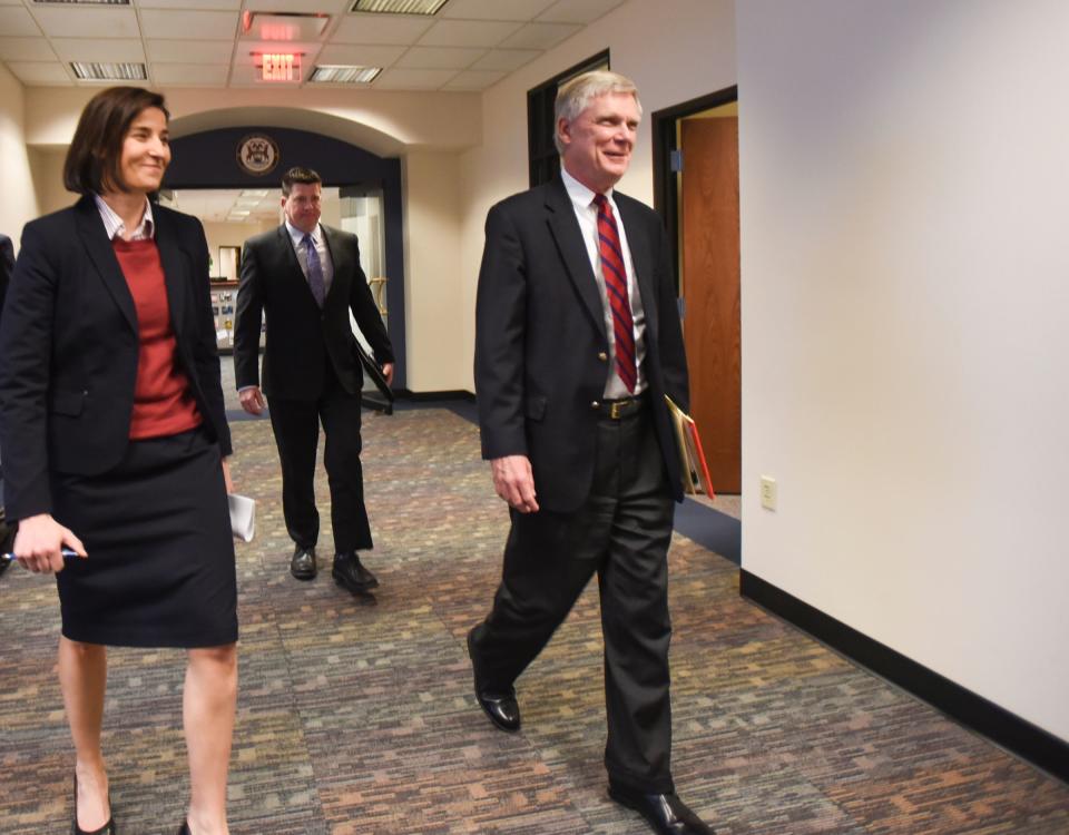 From left.  Assistant Attorney General Christina Grossi, Special Agent David Dwyre, and Special Prosecutor Bill Forsyth head in for a press conference, Friday, Dec. 21, 2018, at the Office of the Attorney General, regarding MSU's handling of the Nassar matter.  [AP Photo/Matthew Dae Smith/Lansing State Journal]