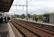 Travelers wait for trains on the platform of the station of Saint Jean de Luz, southwestern France, Friday, Oct.18, 2019. A wildcat strike is disrupting train travel around France, as railway workers demand better security after a recent accident. (AP Photo/Bob Edme)