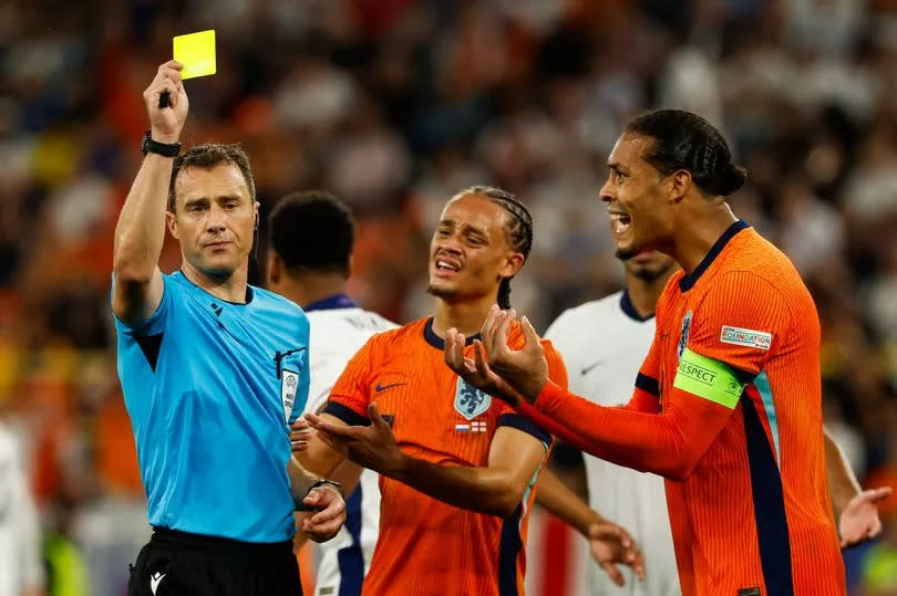 Netherlands players Virgil van Dijk and Xavi Simons protest to the referee